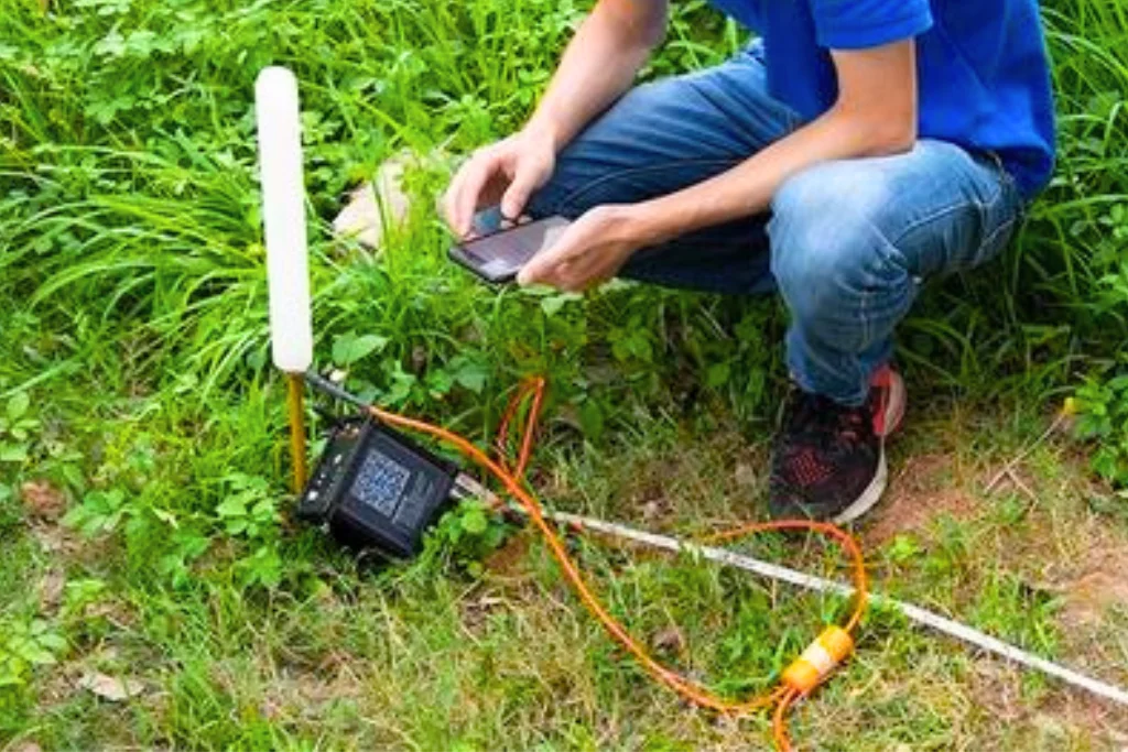 Surveyor using PQWT-M100 Water Detector for groundwater detection in a mountain terrain